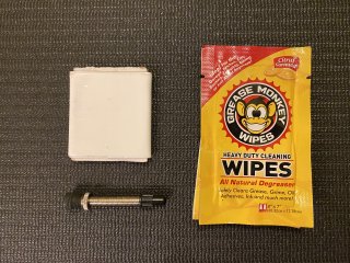 Grease Monkey wipes, small roll of Gorilla tape, and spare tubeless valve