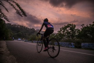 Cyclist riding a road bike at sundown